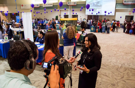 Univision Reporter interviewing a woman durring an Feria de Educacion event at Sacramento State