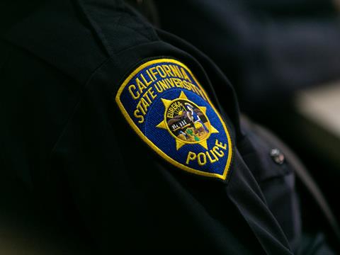 A close up of a C S U police officers patch