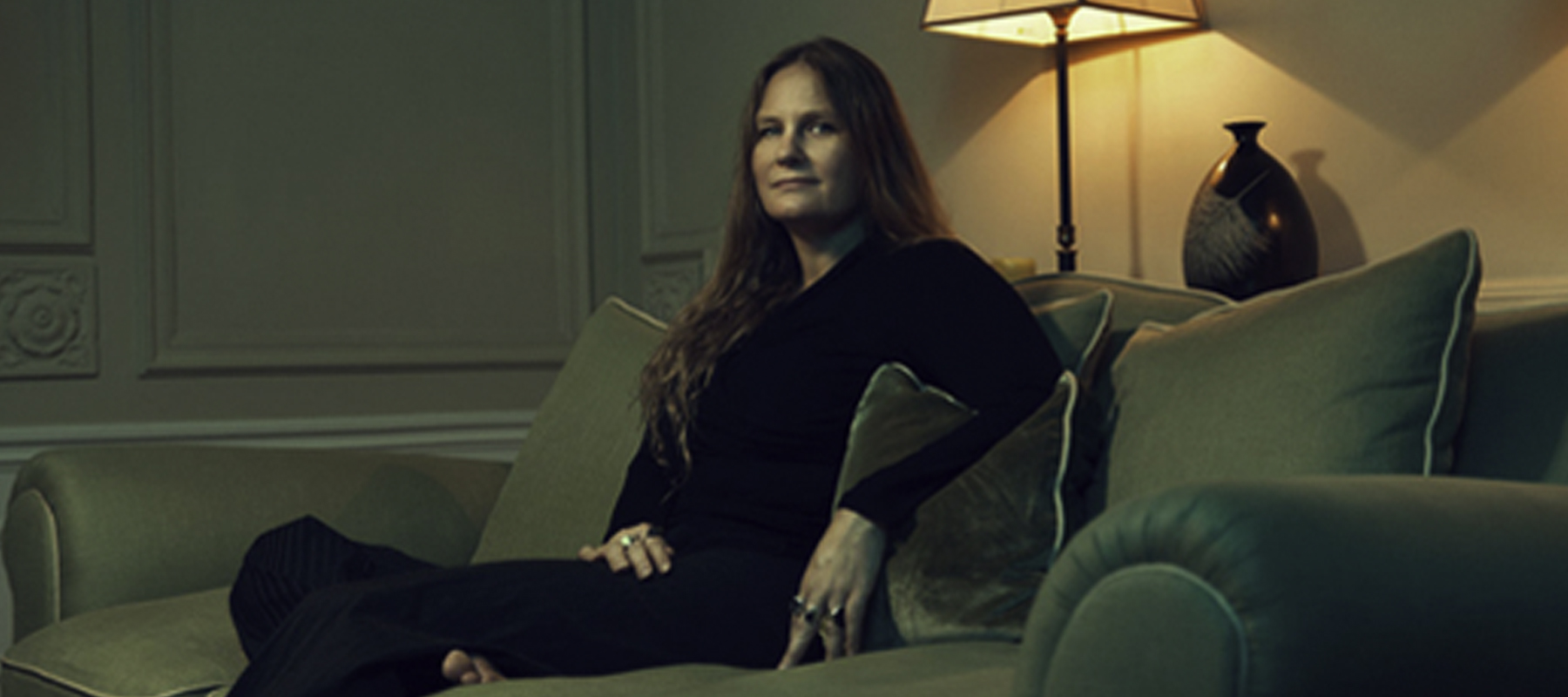Lidia Yuknavitch sitting on a couch