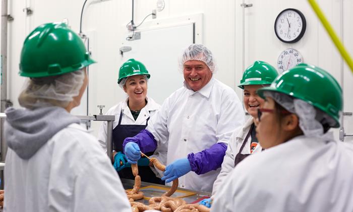 Chancellor White learns to make sausage at Cal Poly San Luis Obispo in 2015.