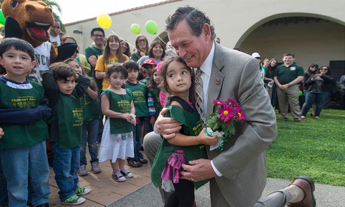 Chancellor White with kids at Cal Poly Pomona in 2013.