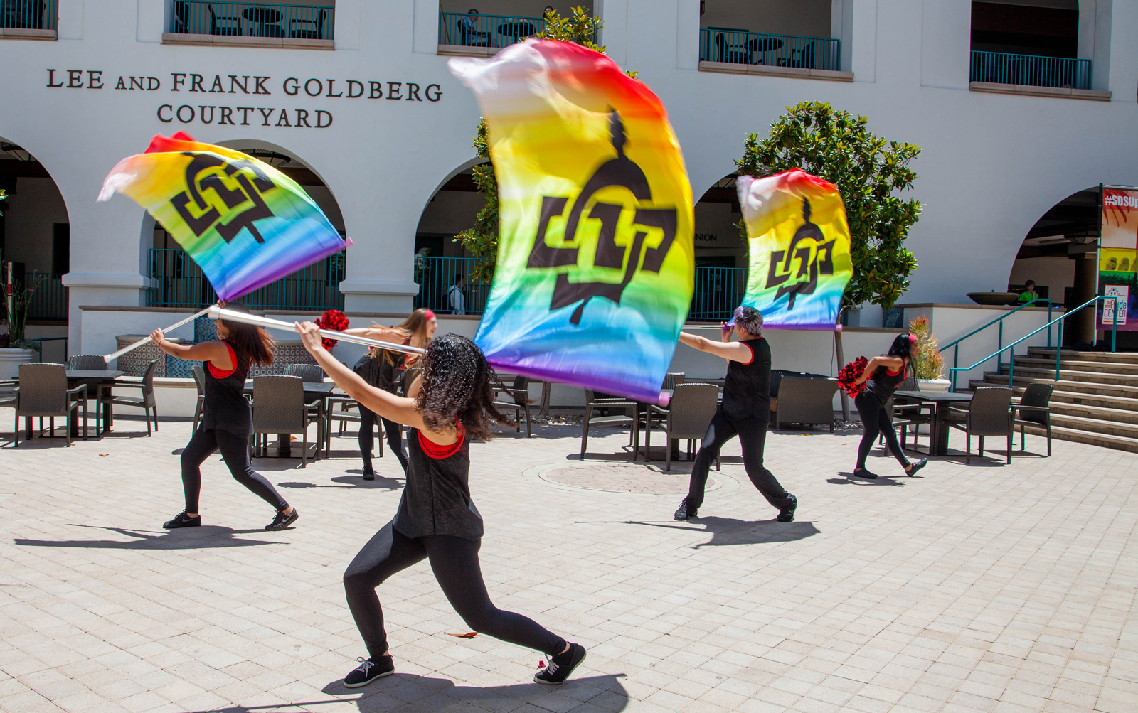 Members of SDSU’s Color Guard perform at the rainbow flag raising celebration.