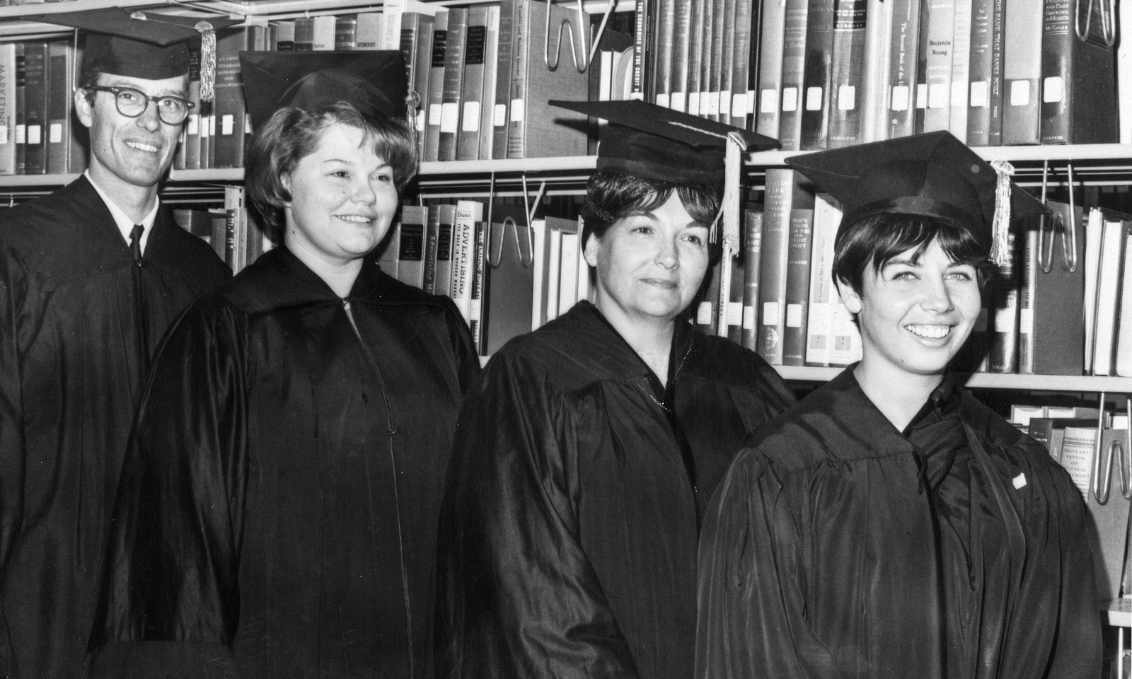 The first four graduates of CSUDH stand in the campus library, June 9, 1967. (left to right) William Hart, Pamela Striplin, Othi