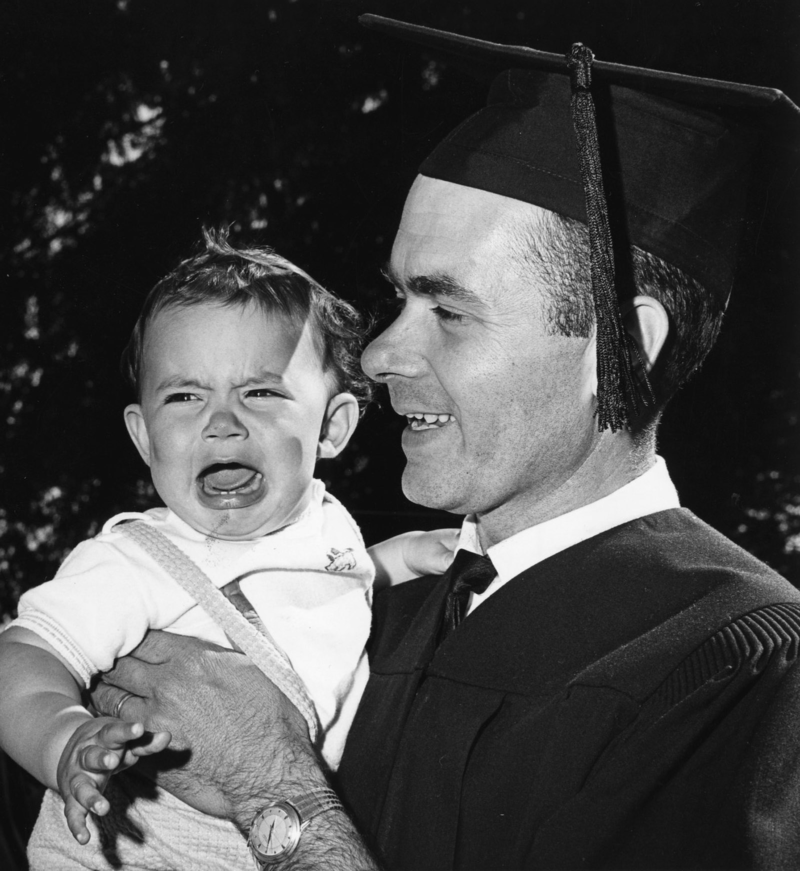 Kenneth Hinman holds his son Todd after his 1963 graduation, in which he received a bachelor’s of arts in teaching.