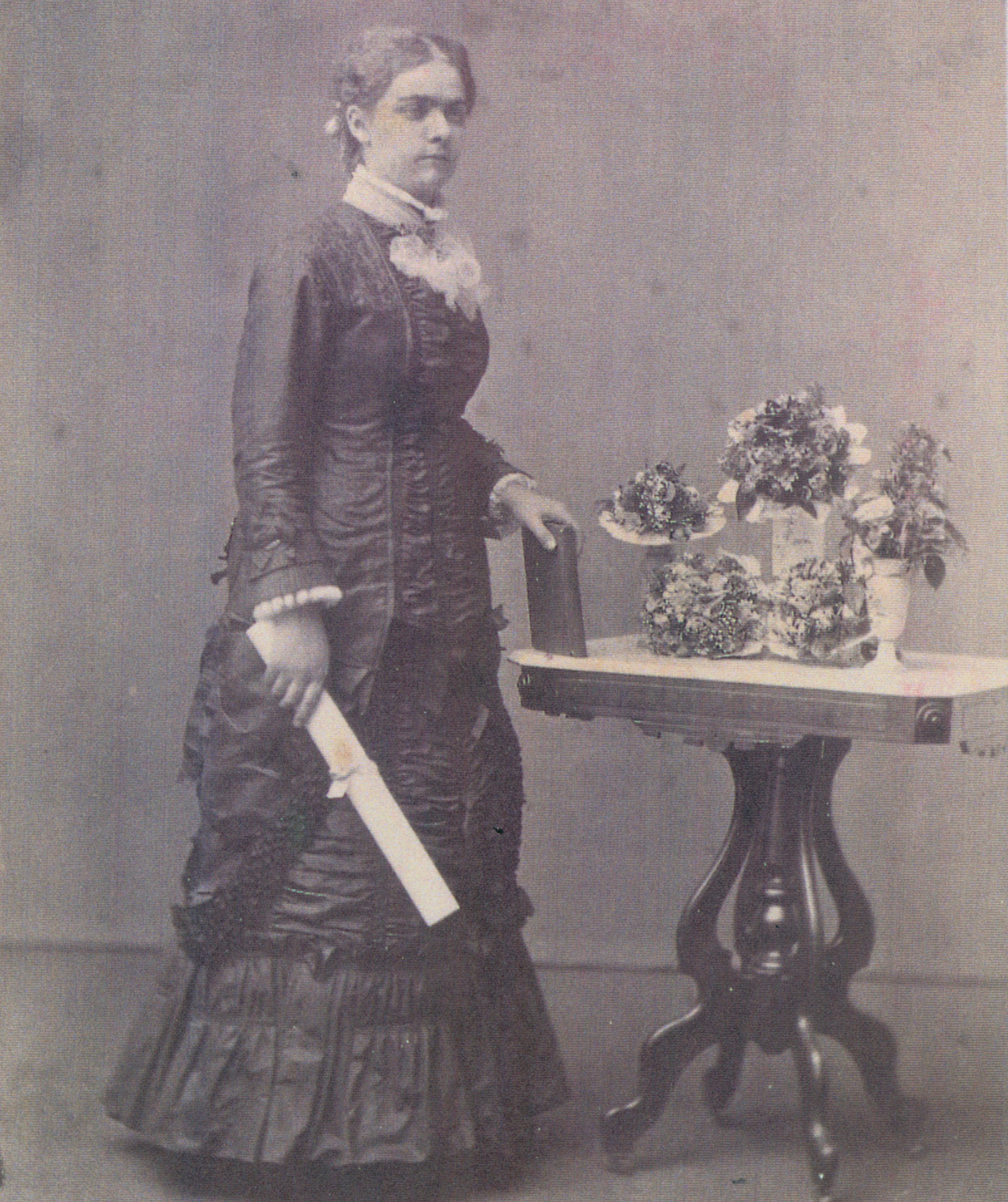 Sarah Locke poses in her graduation photograph, May 21, 1880. The dress worn in the photograph is also in the Sarah Locke Smith 