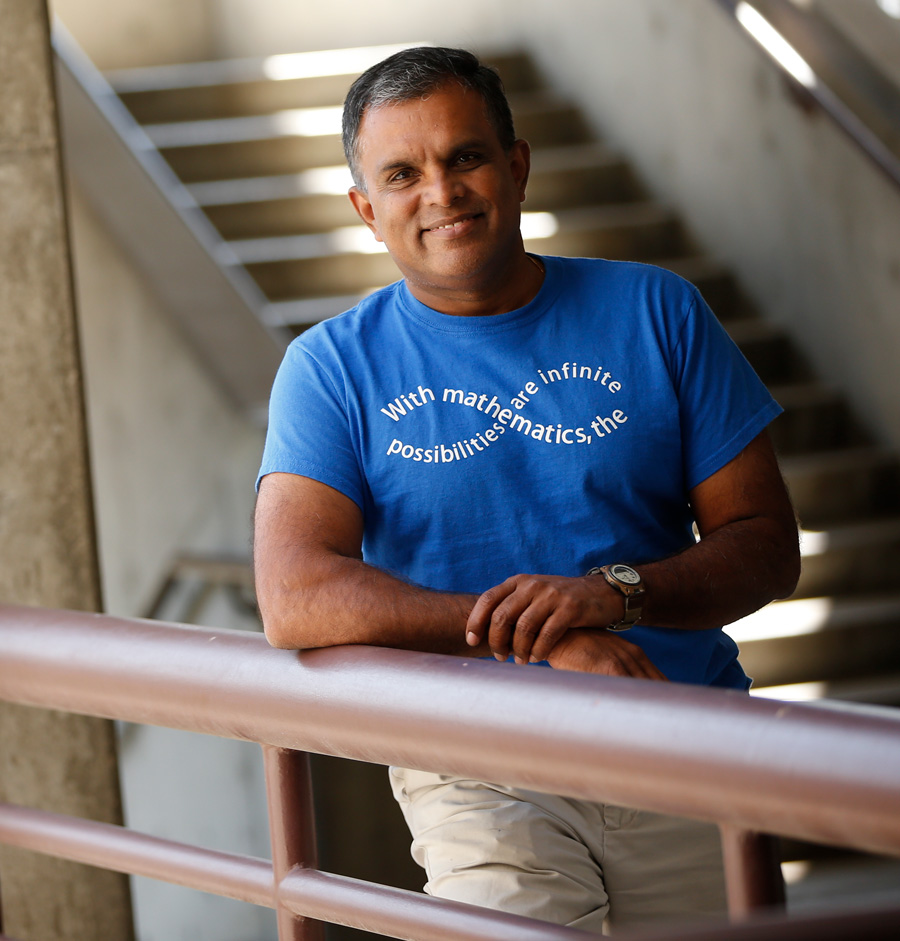 Dr. Rajee Amarasinghe poses in a stairway.
