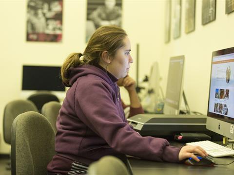 College student sitting at a computer