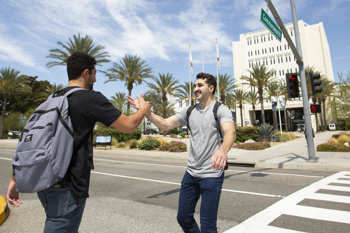Kian Balbus, left, greets Zhar Ismal on their first day of classes after a summer apart on Aug. 26, 2019. 
