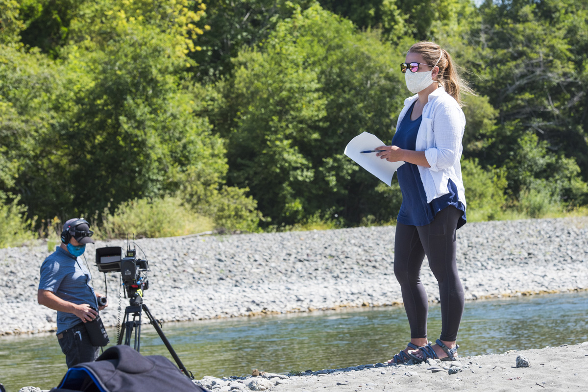 Humboldt State lecturer Amanda Admire wears a mask during the COVID-19 pandemic while filming river geomorphology .