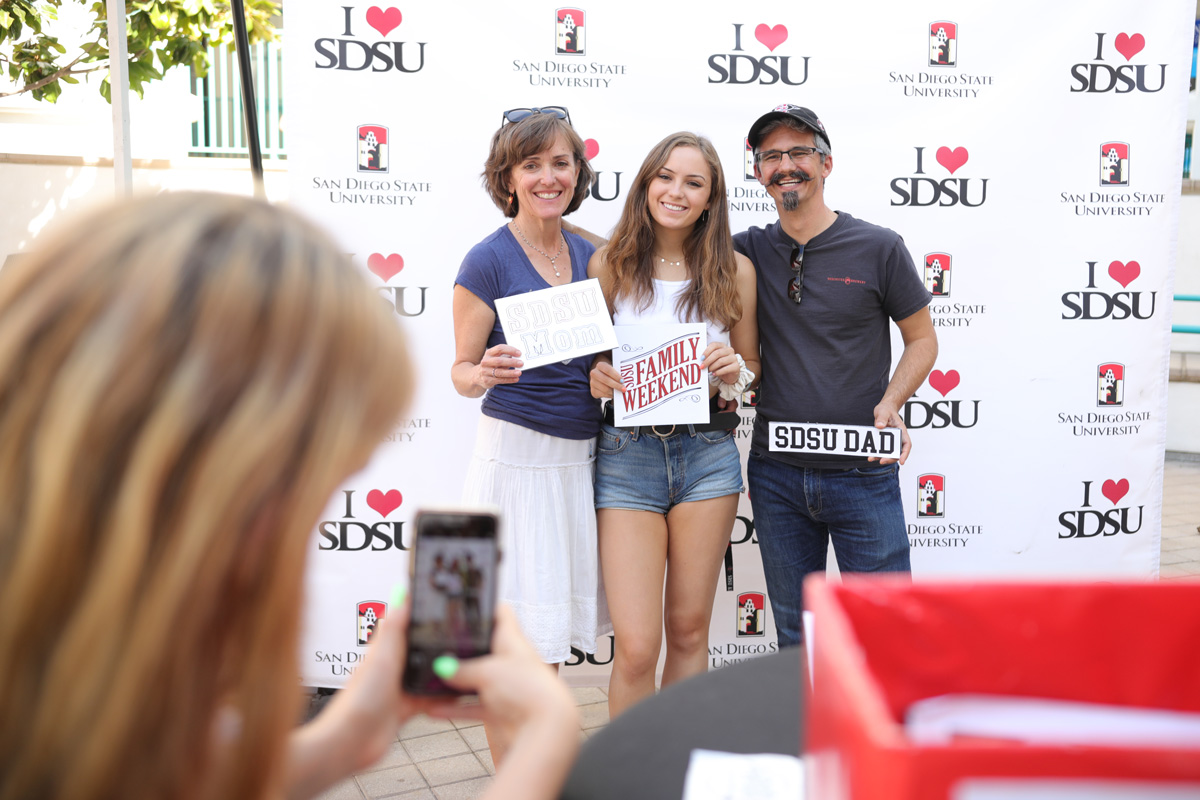 A student poses for a photo with her family on Oct. 11, 2019 during family weekend. ​