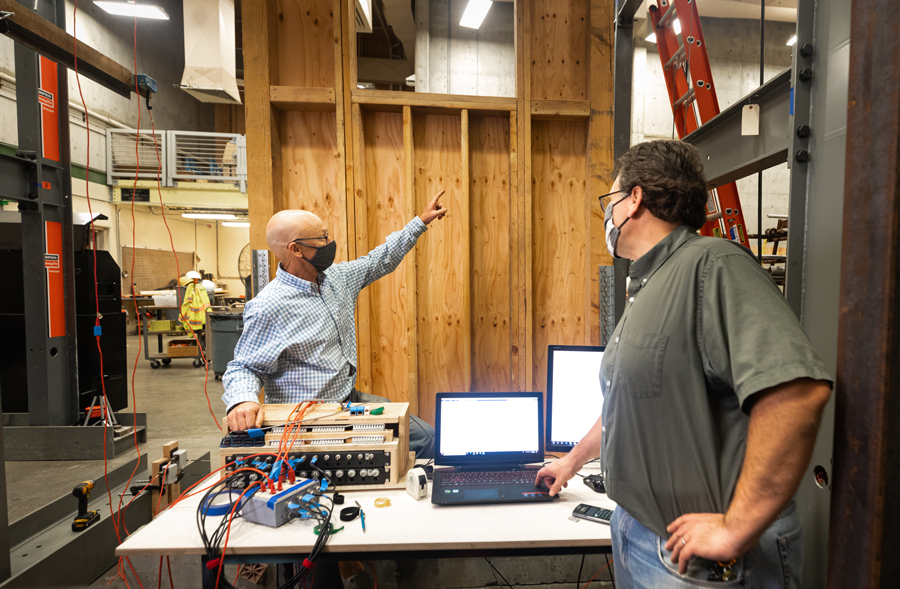 Professors John Lawson and Michael Deigert compare the computer results with actual conditions from a full-scale test on plywood walls, conducted by the students in their Fall 2020 ARCE 451 Wood/Masonry Design lab classes.