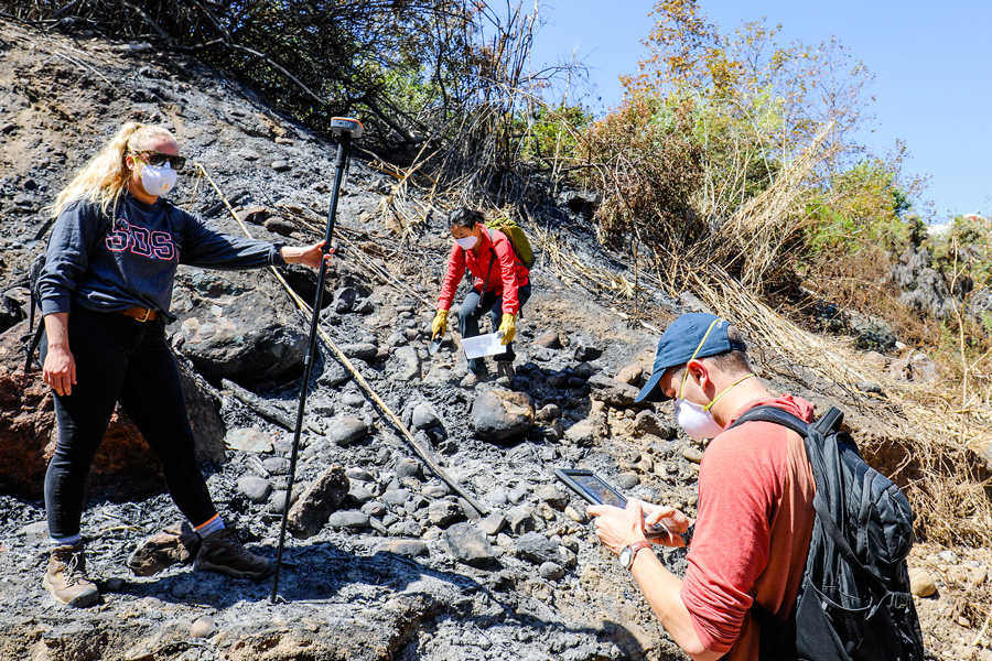 Engineering professor Alicia Kinoshita, Ph.D., and San Diego State students collect environmental samples to assess wildfire damage. 