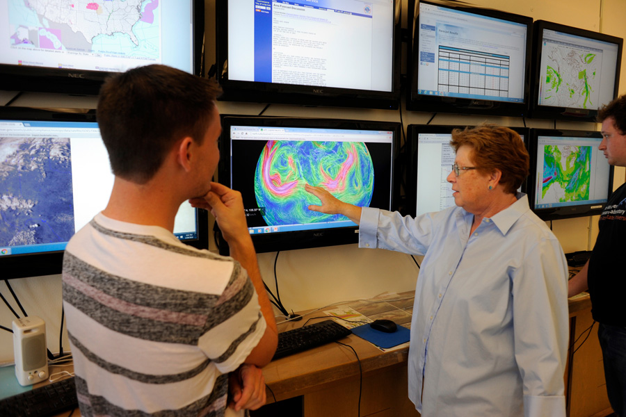 Meteorology Professor Alison Bridger demonstrates her department's “map wall” weather monitors and interacts with her students in the classroom, February 29, 2016. Photo: Neal Waters 