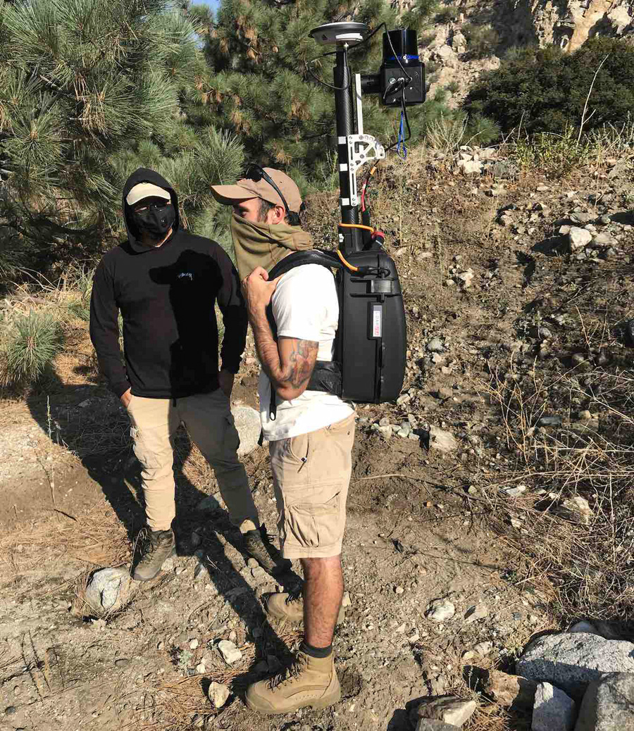 CSUSB Master of Science students, Seth Clemen Saludez (left) and Andrew Suarez (right), performing a scan with mobile backpack LIDAR technology at Mill Creek Fault in Mill Creek, San Bernardino Mountains. 