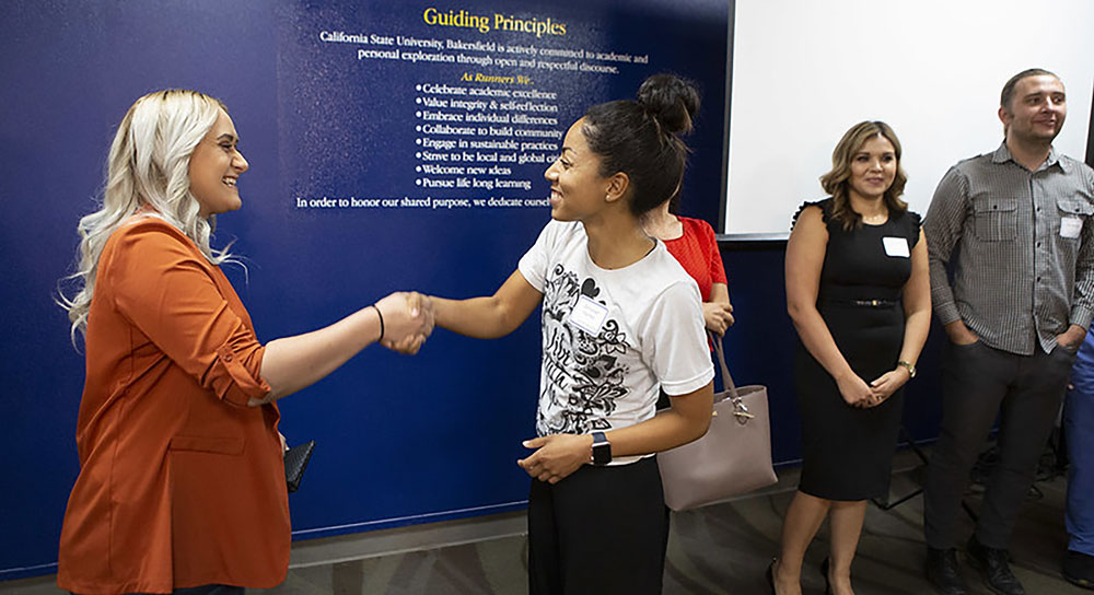 A mentee-mentor pair meet at an event held to kick off the 2019-2020 cycle of the `Runner Alumni Mentor Program at CSUB.