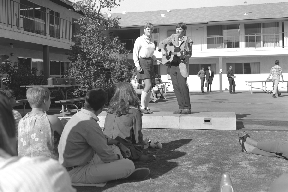 A groovy musical duo performs on a platform in the Watt Campus courtyard, 1968. 