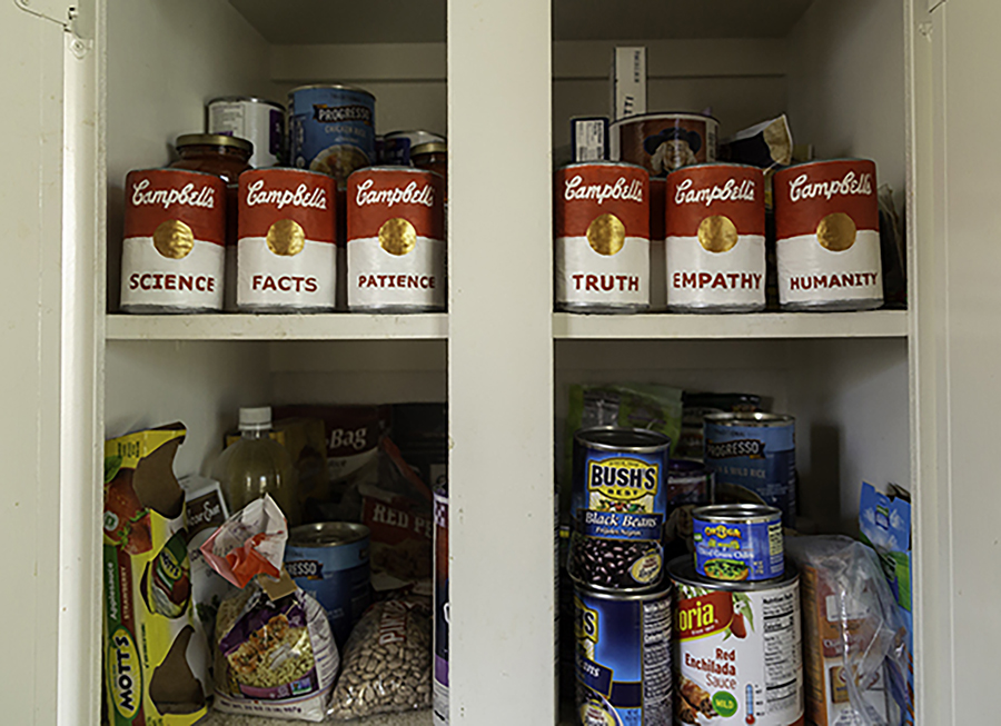 A sculptural installation featuring dried goods, canned foods and Campbell’s soup cans bearing the words “science, facts, patience, truth, empathy, humanity.”
