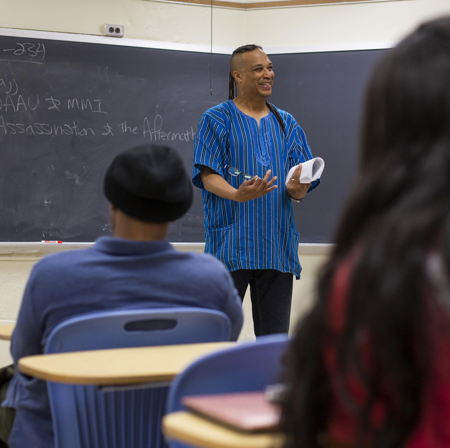 Cal State East Bay professor Nicholas Baham, III, Ph.D., in front of his class.