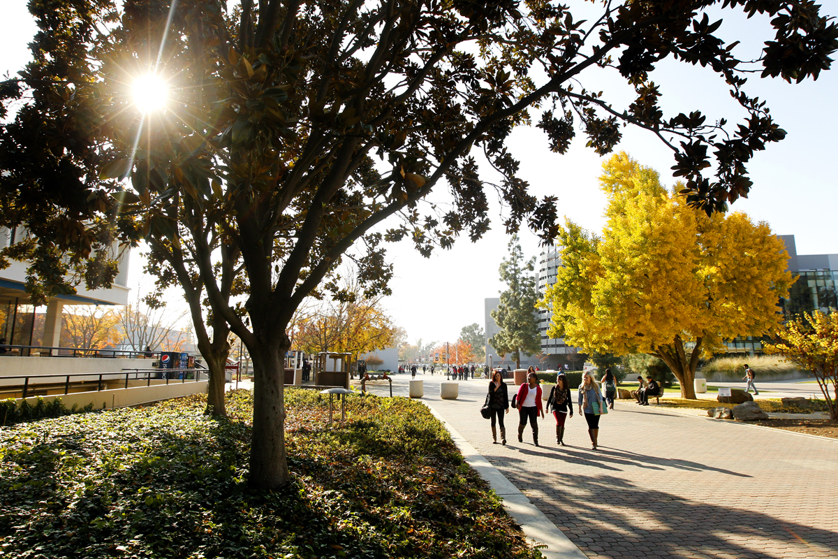 ​Students walk past the free speech area on campus at Fresno State