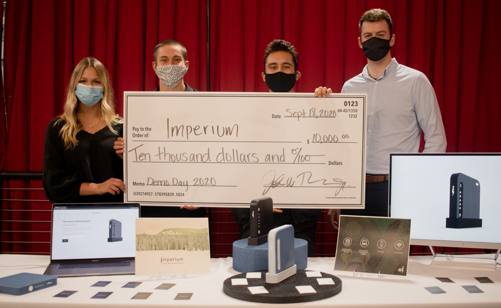Entrepreneurs behind the startup Bridge hold up their $10,000 check