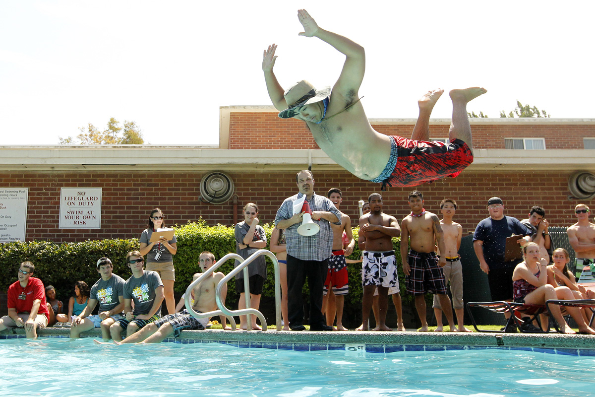 Manny Luna jumps into the residence hall pool during a Water Olympics competition