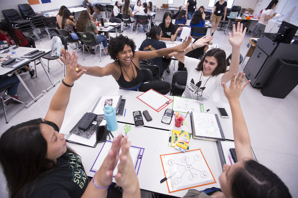 Brynn Campos, middle left, celebrates with her teammates after correctly solving a polynomial equation at CSUF