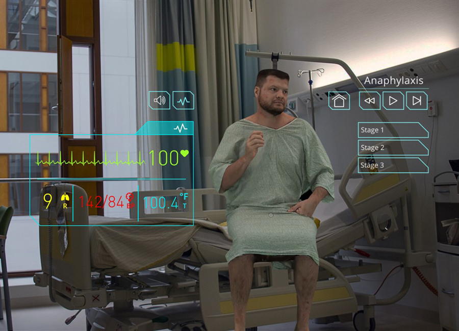 Holographic image of a patient actor sitting on a hospital bed.