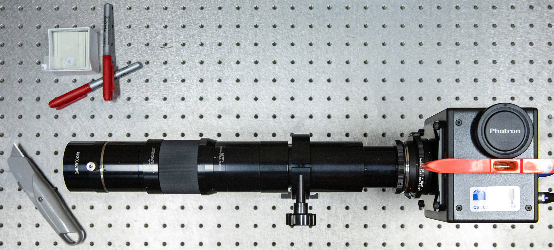 A camera with a long-distance microscope lens used to capture high-speed, high-resolution video for data analysis.