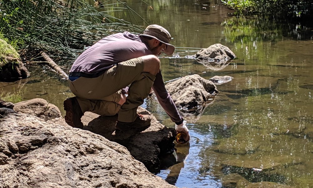 researcher taking water samples